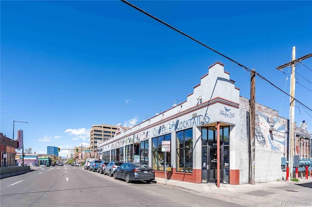 1300 N Ogden St Unit 304, Denver, CO 80218 - view of asphalt street featuring street lighting, sidewalks, curbs, and traffic lights