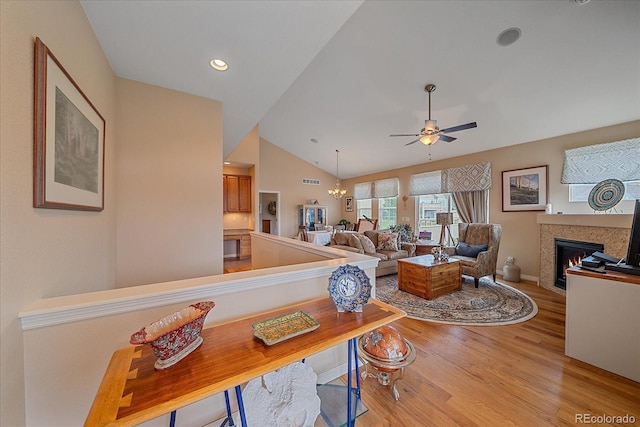 22124 E Euclid Dr, Aurora, CO 80016 - living area featuring light wood finished floors, ceiling fan, lofted ceiling, a glass covered fireplace, and recessed lighting