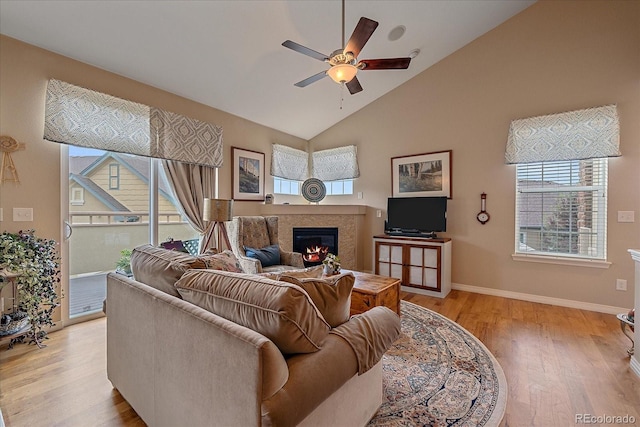 22124 E Euclid Dr, Aurora, CO 80016 - living area featuring ceiling fan, a glass covered fireplace, plenty of natural light, and high vaulted ceiling