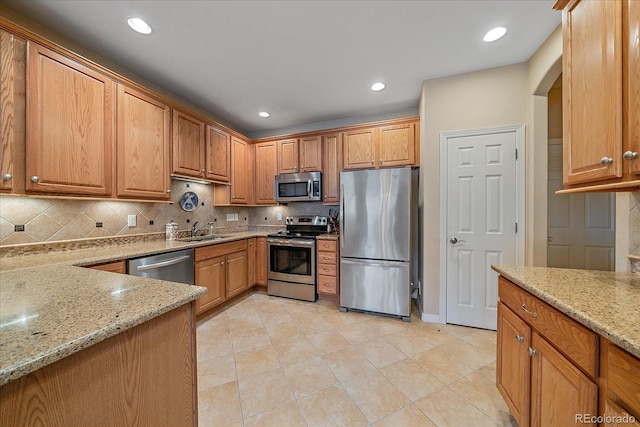 22124 E Euclid Dr, Aurora, CO 80016 - kitchen with stainless steel appliances, light stone countertops, decorative backsplash, and recessed lighting