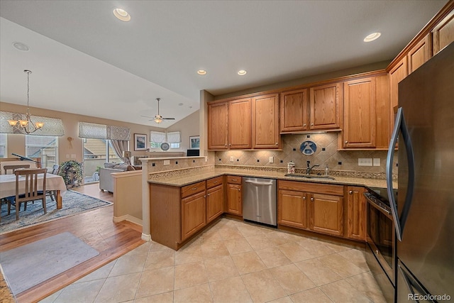 22124 E Euclid Dr, Aurora, CO 80016 - kitchen featuring appliances with stainless steel finishes, a peninsula, tasteful backsplash, brown cabinetry, and light stone countertops