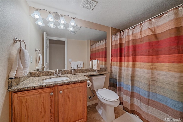 22124 E Euclid Dr, Aurora, CO 80016 - bathroom featuring tile patterned flooring, vanity, and a textured ceiling
