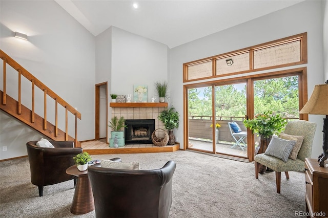 living room featuring high vaulted ceiling, light carpet, and a fireplace