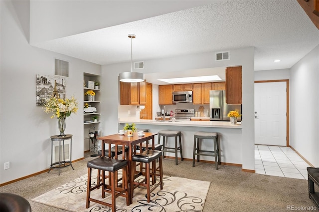 carpeted dining room with a textured ceiling