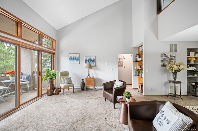 interior space featuring light colored carpet and high vaulted ceiling