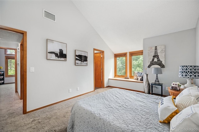 bedroom with high vaulted ceiling and light colored carpet