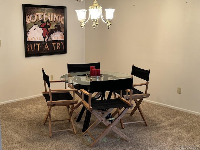 carpeted dining room with baseboards and a chandelier