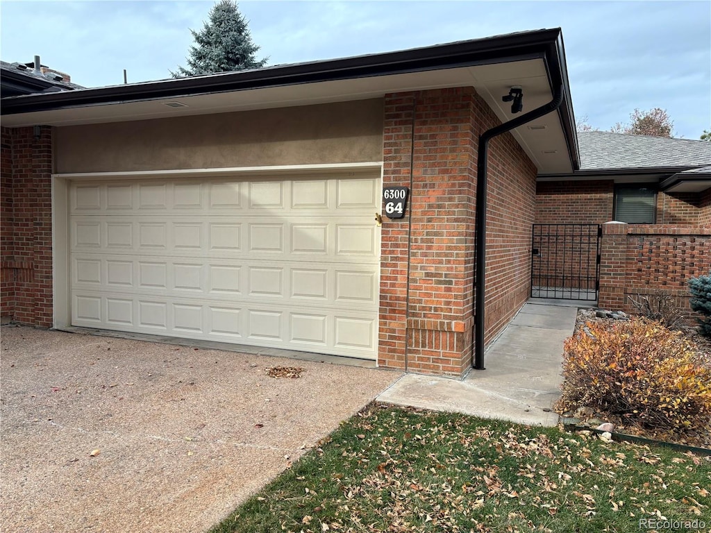 garage featuring concrete driveway