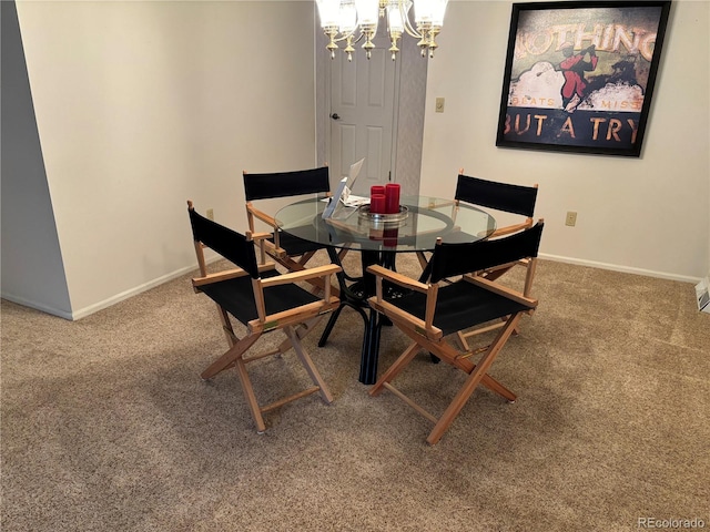 carpeted dining space with baseboards and a chandelier