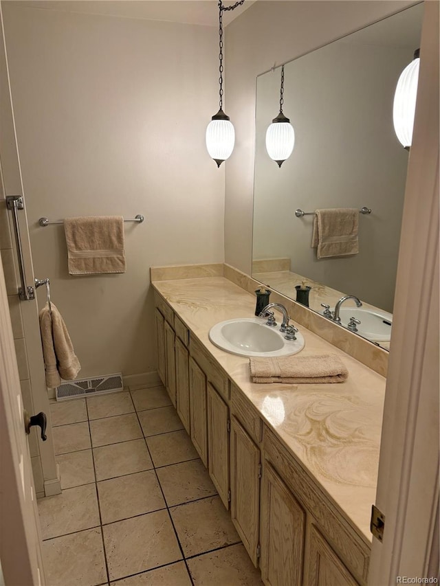 bathroom with visible vents, baseboards, vanity, and tile patterned flooring