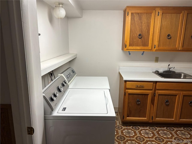 laundry area with a sink, cabinet space, and washer and clothes dryer