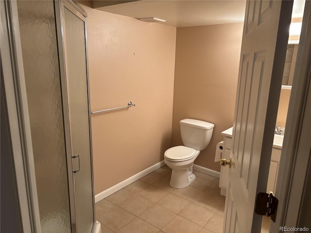 full bathroom featuring toilet, a shower stall, tile patterned flooring, baseboards, and vanity