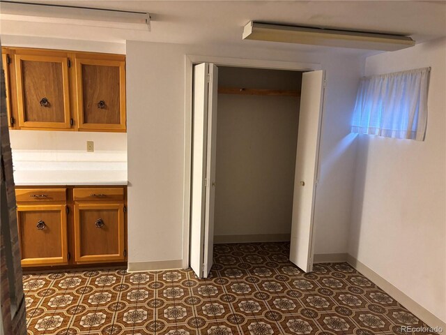 interior space featuring tile patterned flooring and baseboards