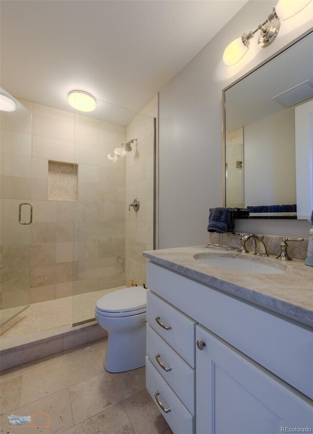 1077 Canyon Blvd Unit 403, Boulder, CO 80302 - bathroom with vanity, toilet, and a shower with shower door