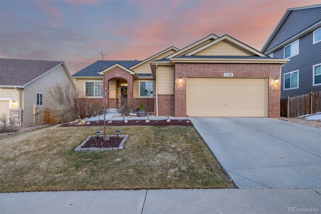 ranch-style house featuring a garage, driveway, fence, a yard, and brick siding