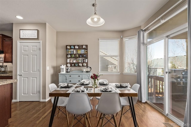 dining room featuring dark wood finished floors and baseboards