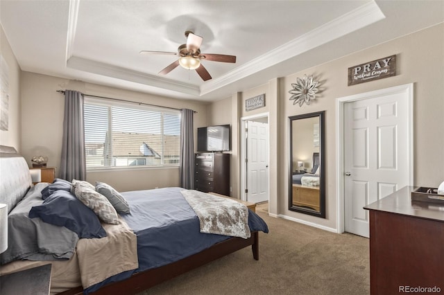 bedroom featuring light carpet, baseboards, ceiling fan, ornamental molding, and a tray ceiling