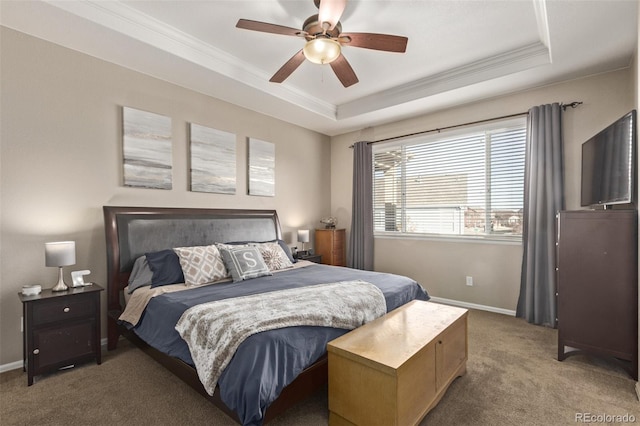 carpeted bedroom featuring crown molding, a raised ceiling, a ceiling fan, and baseboards