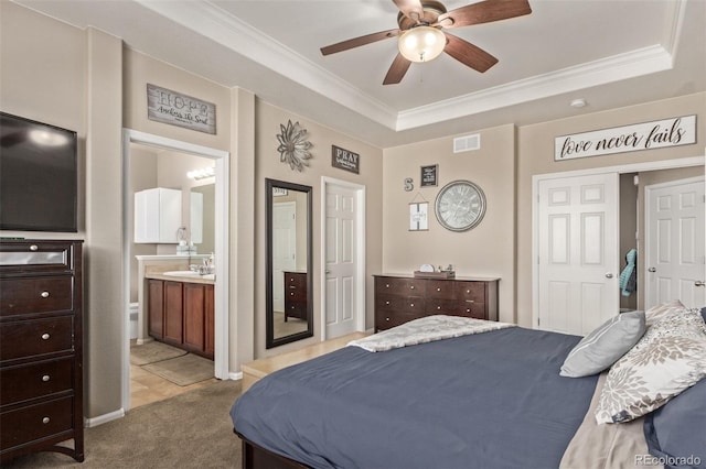 bedroom featuring ornamental molding, a tray ceiling, visible vents, and light carpet