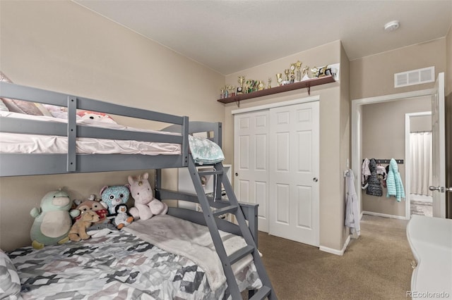 bedroom featuring a closet, carpet, visible vents, and baseboards