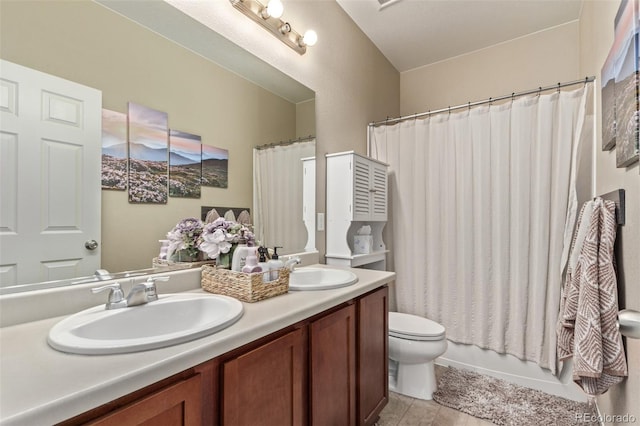 bathroom featuring shower / tub combo, a sink, toilet, and double vanity