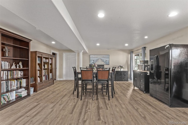 dining area featuring light wood-style floors, baseboards, and recessed lighting