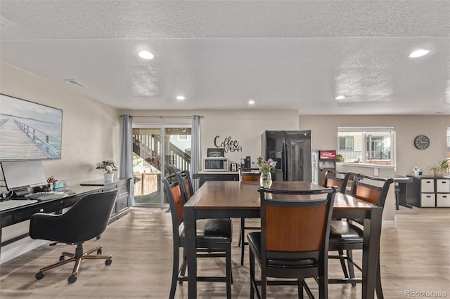 dining space featuring light wood-style flooring, visible vents, and recessed lighting