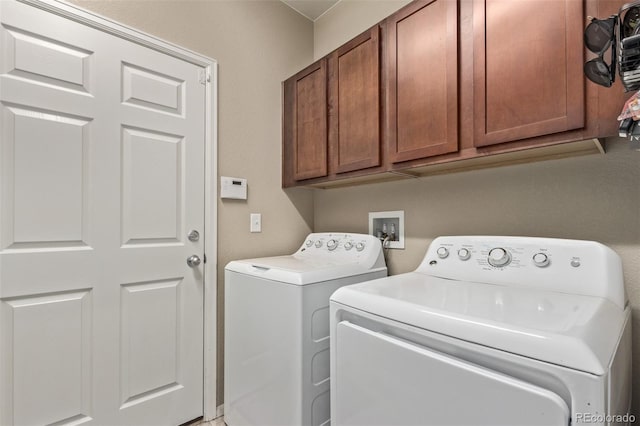 laundry area with cabinet space and independent washer and dryer