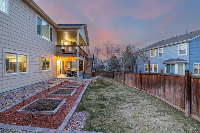 view of yard featuring a patio area, a garden, and a fenced backyard