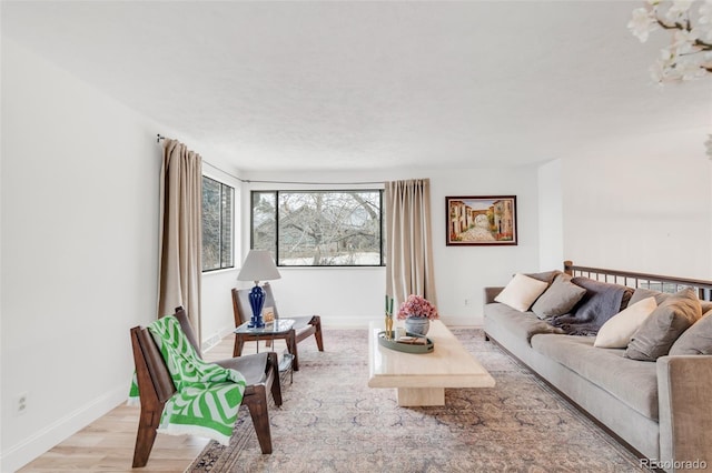 living room with light wood-style flooring and baseboards