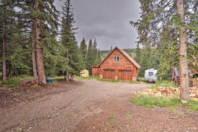 201 Nuthatch Dr, Alma, CO 80420 - view of side of home with a garage, an outbuilding, a view of trees, and driveway
