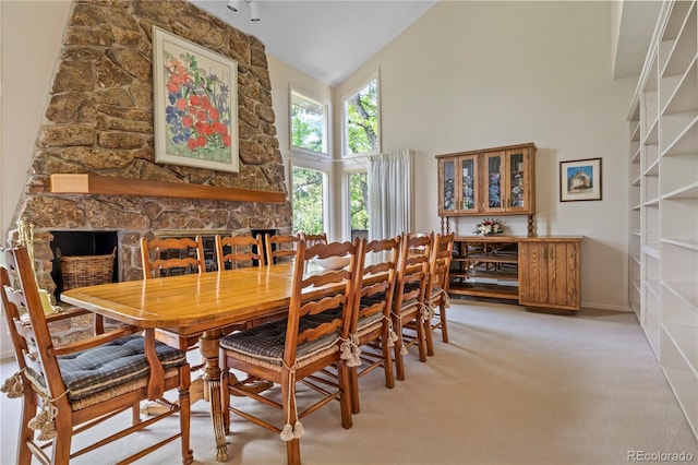 6895 S Norfolk St, Foxfield, CO 80016 - dining space featuring high vaulted ceiling, light colored carpet, and a fireplace