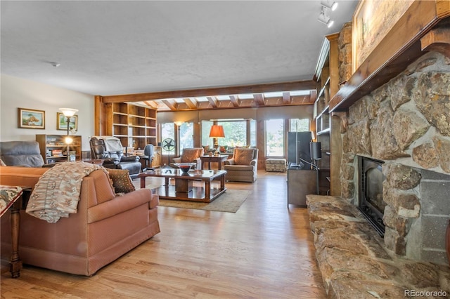 6895 S Norfolk St, Foxfield, CO 80016 - living room with light wood-style flooring and beamed ceiling