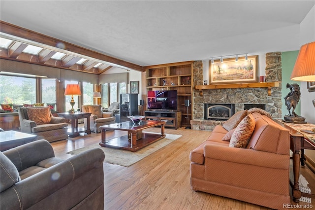 6895 S Norfolk St, Foxfield, CO 80016 - living room featuring a stone fireplace and wood finished floors