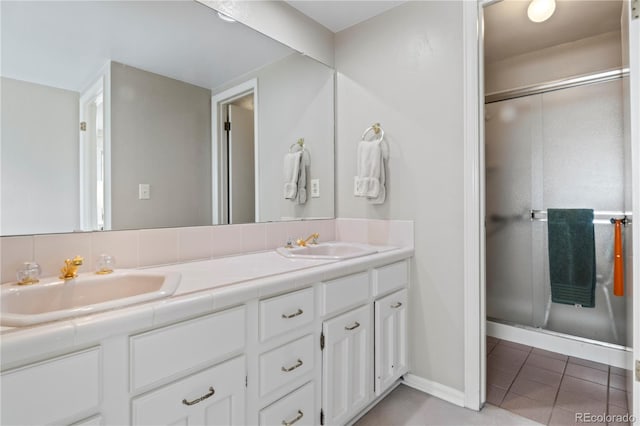 6895 S Norfolk St, Foxfield, CO 80016 - bathroom featuring double vanity, tile patterned flooring, and a stall shower