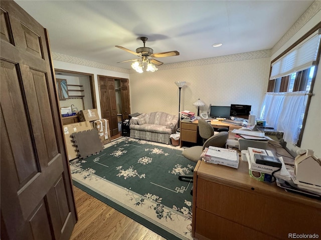 office area with light wood-type flooring and ceiling fan