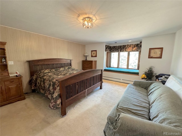 carpeted bedroom featuring a baseboard radiator