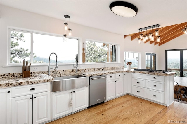 kitchen with light hardwood / wood-style floors, hanging light fixtures, white cabinets, and dishwasher