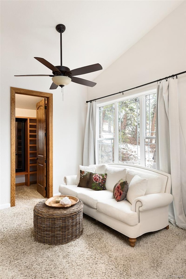 carpeted living room featuring ceiling fan and lofted ceiling