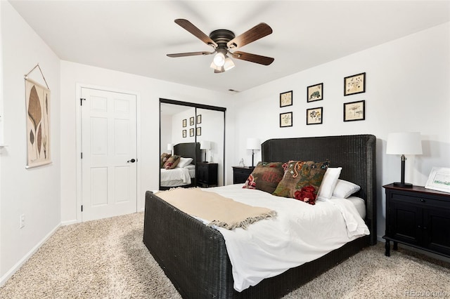 bedroom featuring ceiling fan, a closet, and light carpet