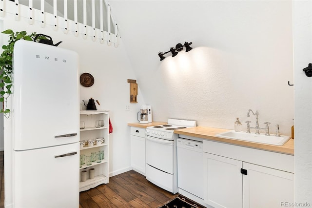 kitchen featuring sink, white cabinets, butcher block counters, and white appliances