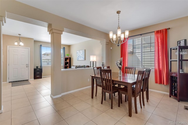 dining space with light tile patterned flooring, a notable chandelier, and a wealth of natural light