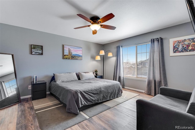 bedroom with baseboards, a ceiling fan, and wood finished floors