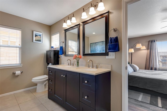 full bath featuring a sink, a wealth of natural light, and ensuite bathroom