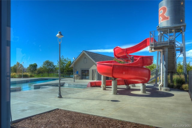 exterior space featuring a swimming pool, a patio area, and stairway
