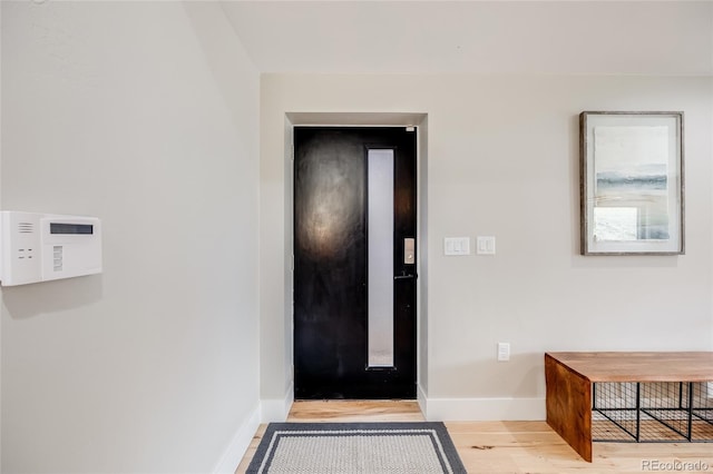 interior space featuring baseboards and wood finished floors