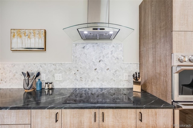 kitchen featuring light brown cabinets, black electric cooktop, backsplash, dark stone countertops, and island exhaust hood