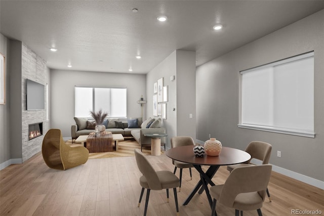 16605 Peak St, Broomfield, CO 80023 - dining space with a fireplace, light wood-style flooring, and recessed lighting