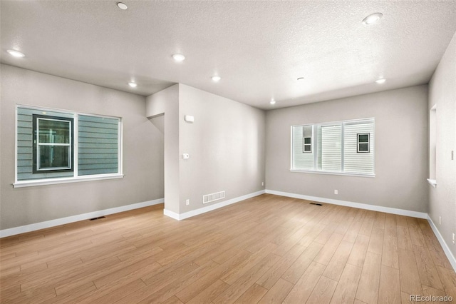 16605 Peak St, Broomfield, CO 80023 - spare room featuring light wood finished floors, a textured ceiling, and recessed lighting