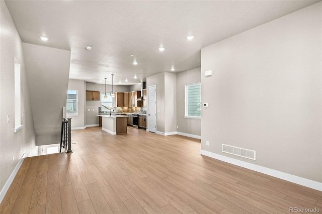 16605 Peak St, Broomfield, CO 80023 - unfurnished living room featuring light wood-type flooring and recessed lighting